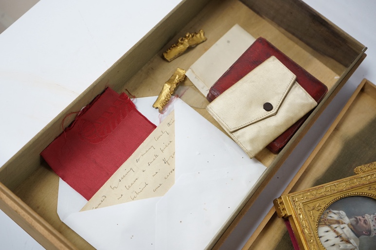 An archive including a pair of miniature portraits on ivory of Edward VII and Queen Alexandra in their coronation robes, in decorative gilt frames with Damask silk backing, 9cm high